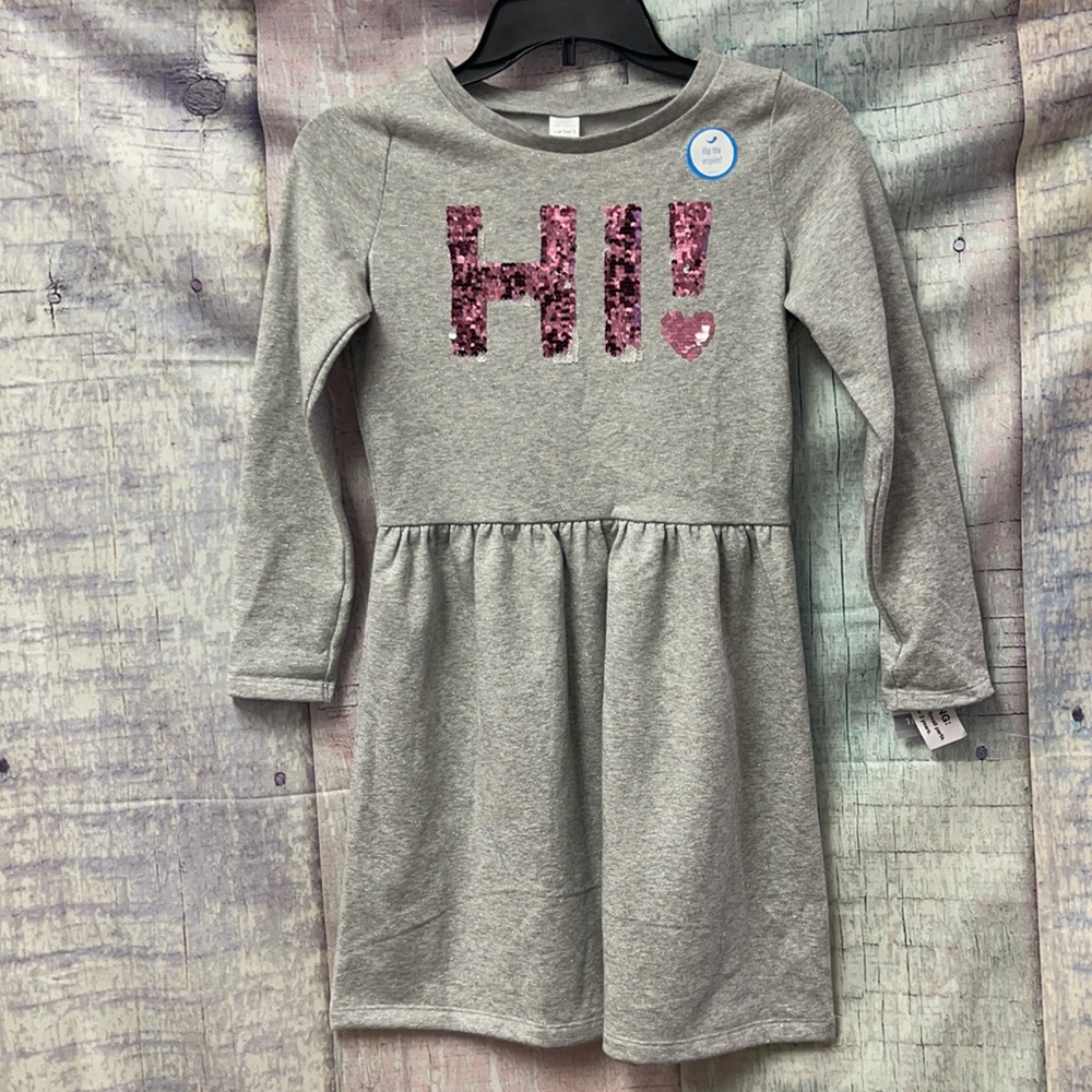Brand new Girls Carter’s dress with sequins. Size 10/12.